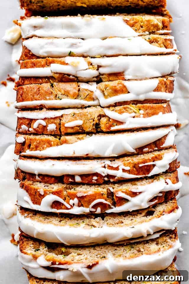 Beautifully sliced and frosted Zucchini Banana Bread, showcasing its moist texture and delicious vanilla icing.