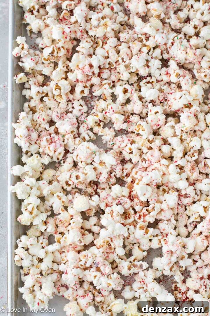 Finished peppermint white chocolate popcorn with candy cane sprinkles.
