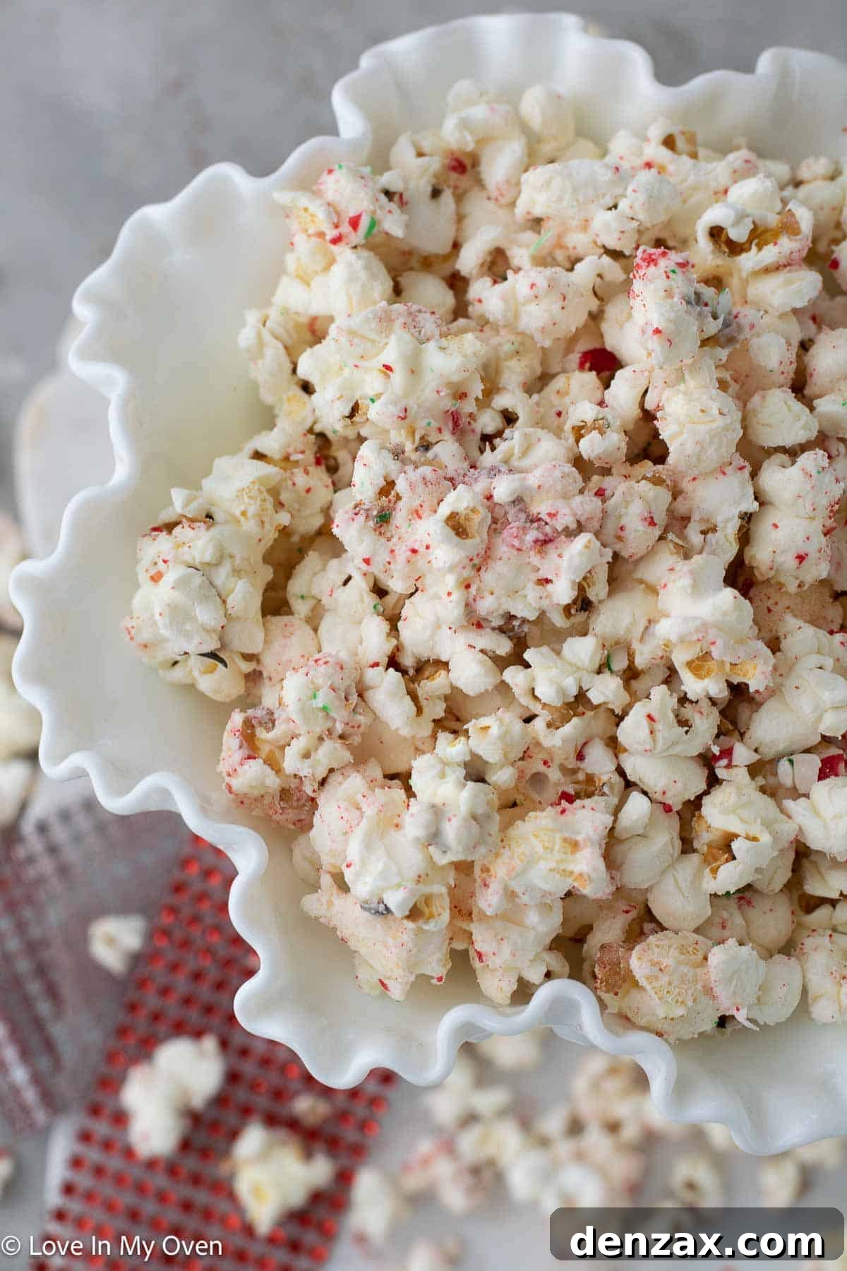 Large bowl of Peppermint White Chocolate Popcorn with a festive backdrop.