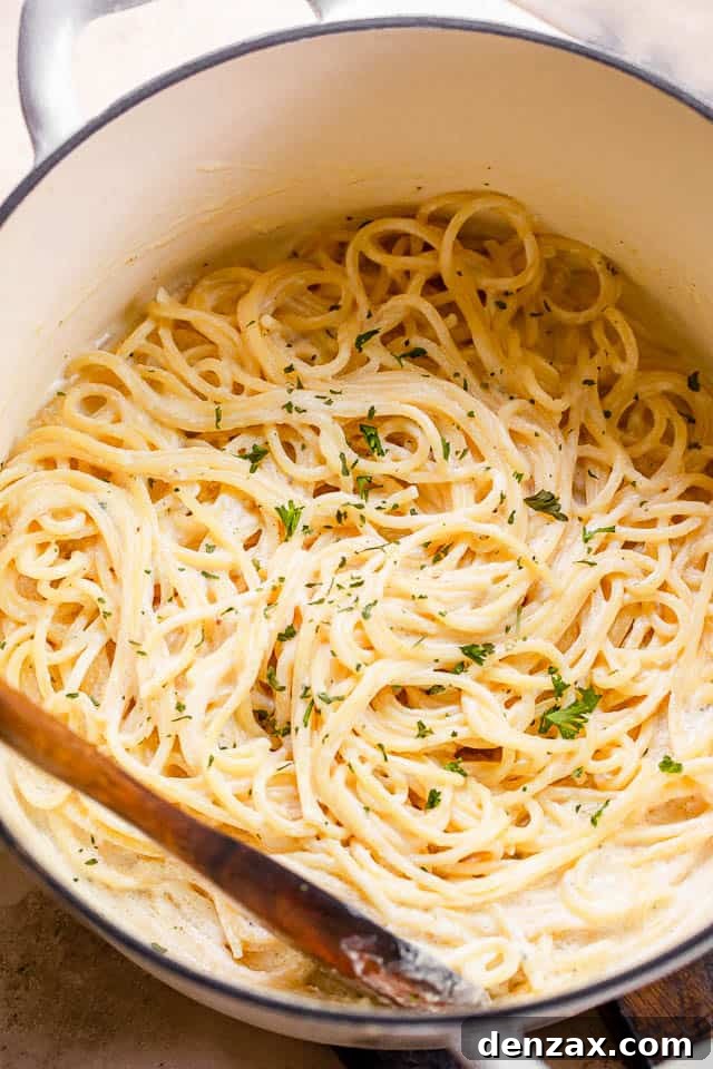 This quick Cream Cheese Spaghetti offers a comforting, cheesy, and creamy pasta dinner that's downright delicious! top shot of cream cheese spaghetti in a white pot