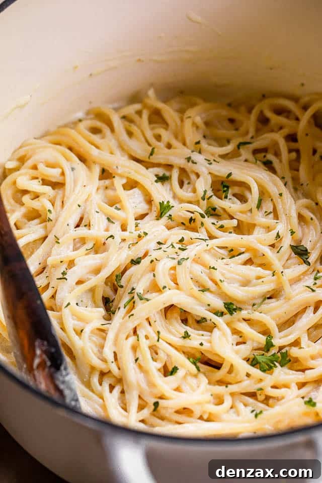This quick Cream Cheese Spaghetti offers a comforting, cheesy, and creamy pasta dinner that's downright delicious! cooked spaghetti in a white dutch oven