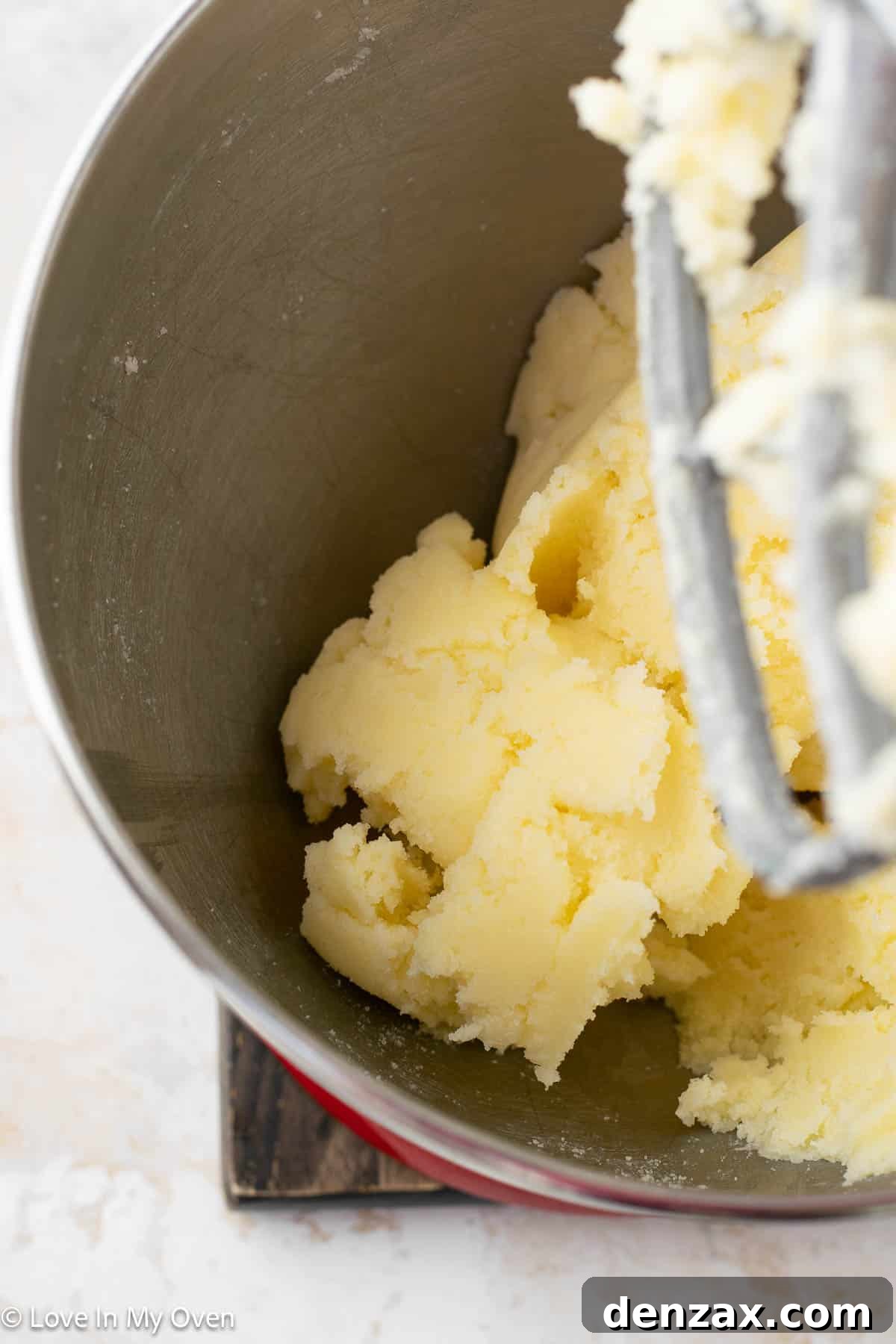 Step-by-step image of sprinkles being folded into cake batter