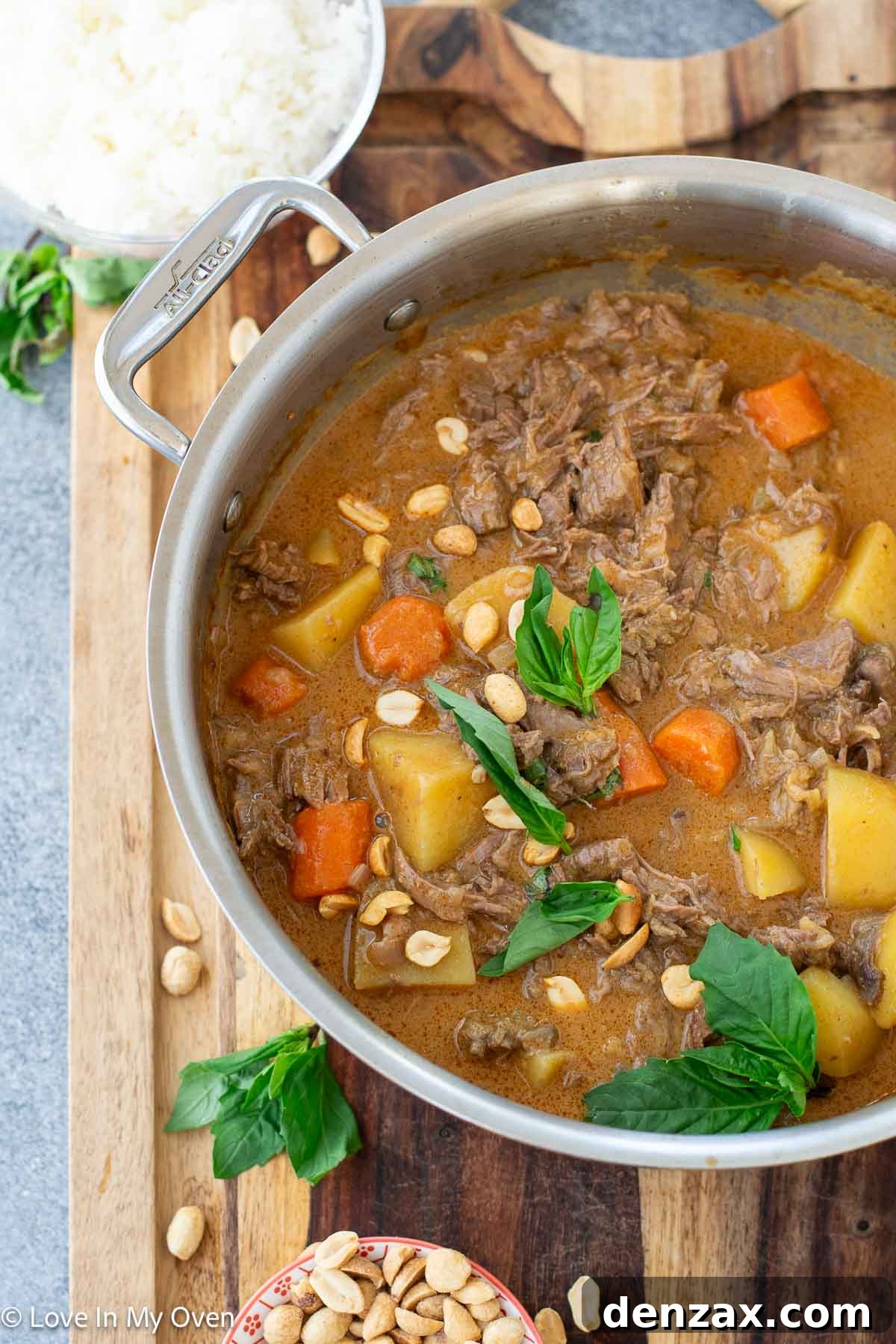 plated beef massaman curry with rice and garnishes