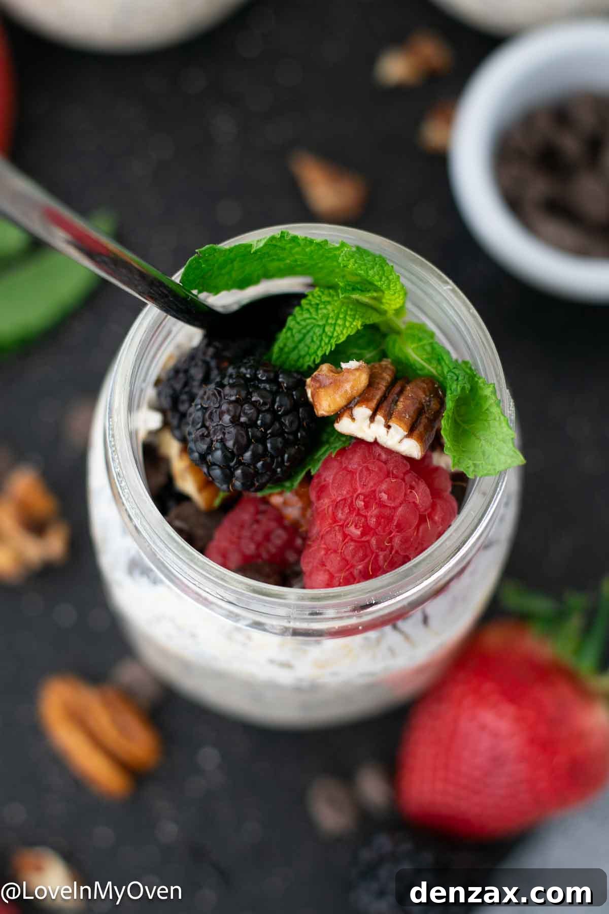 Two jars of kefir overnight oats, one topped with fruit, the other plain.