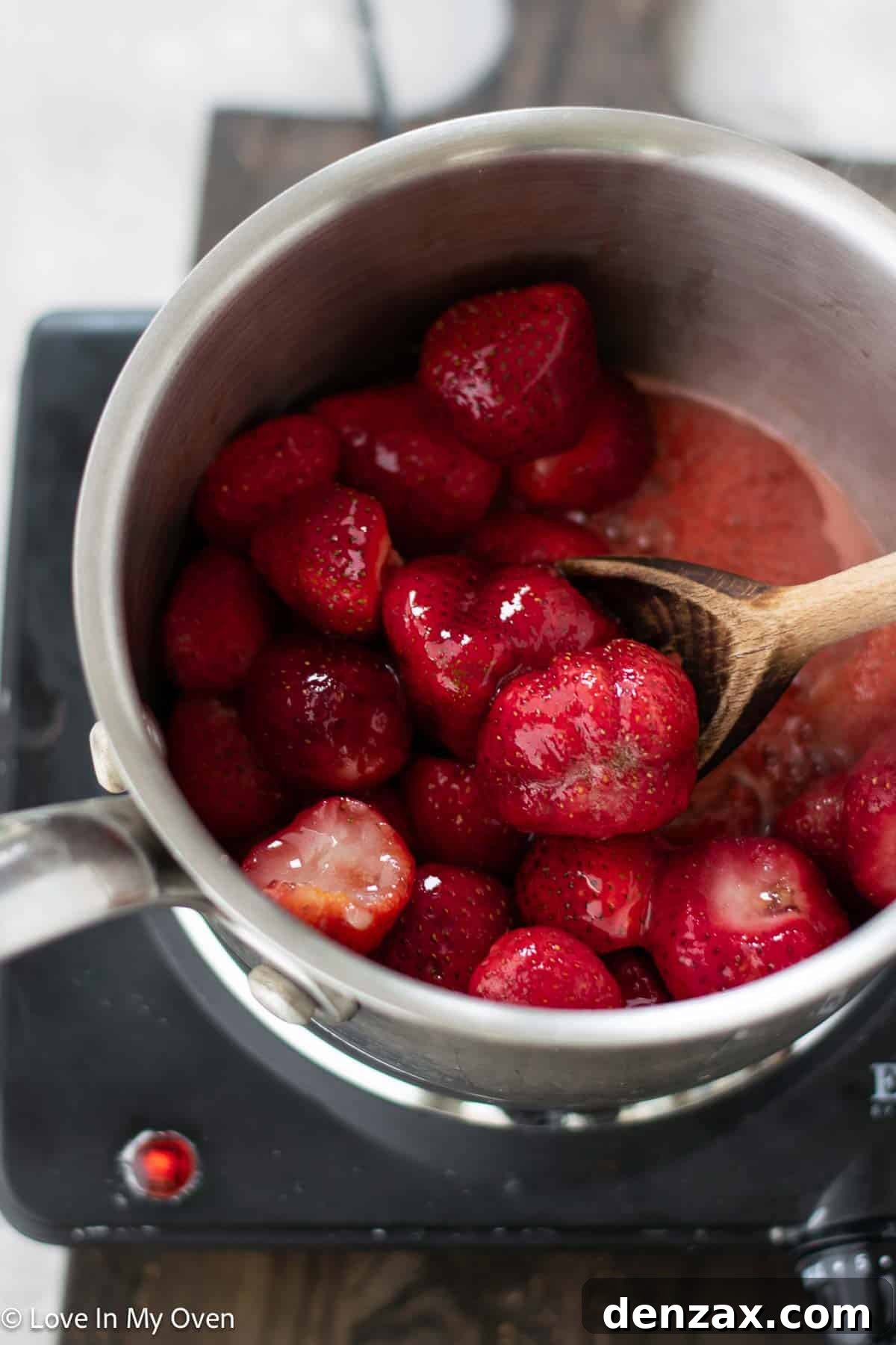 Strawberries, honey, and lemon juice simmering in a saucepan for the sauce