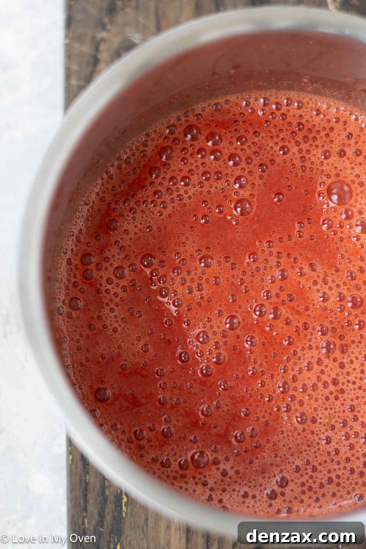 Smooth strawberry puree in a glass measuring cup, ready for the semifreddo