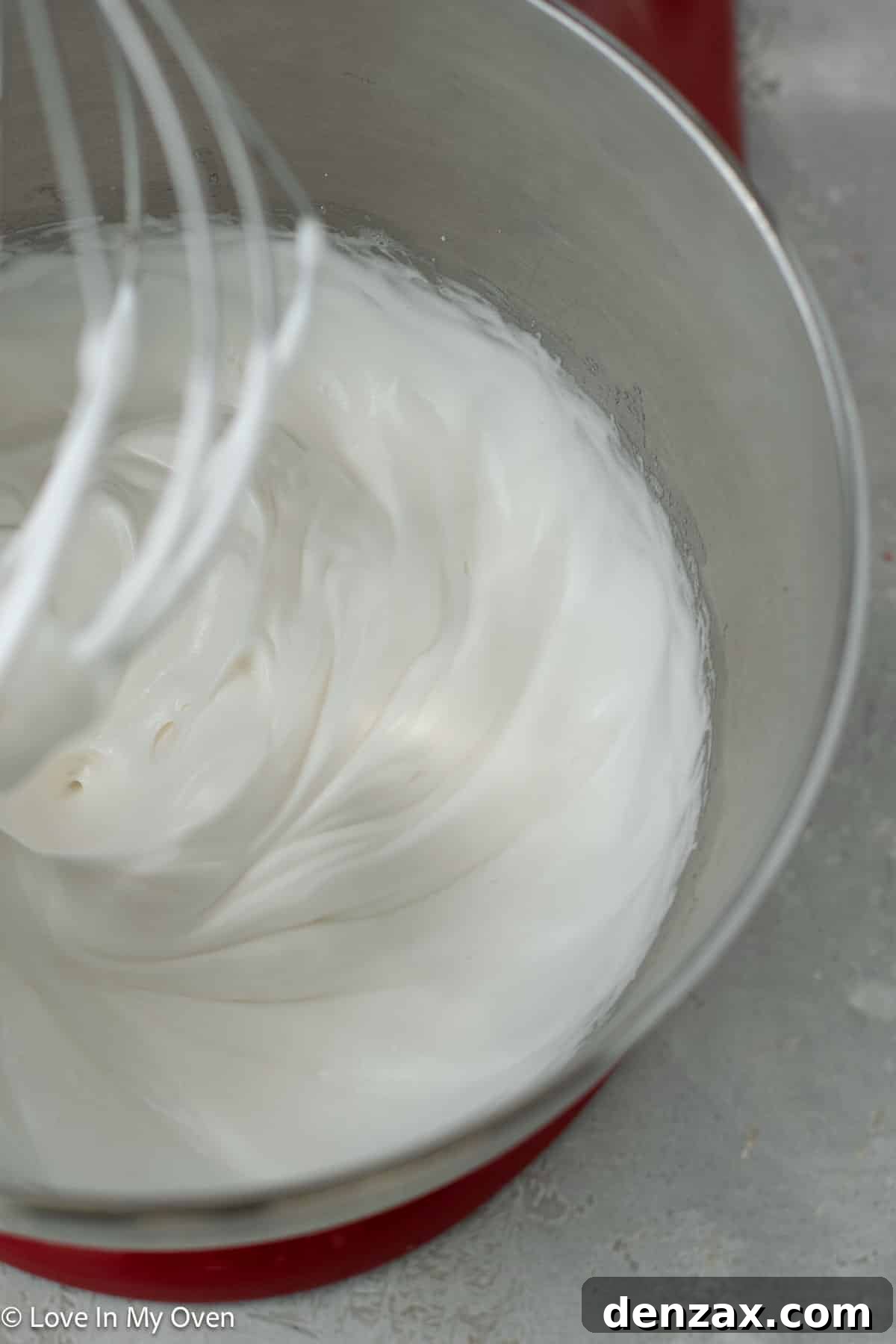 Glossy, stiff-peak meringue in a mixing bowl