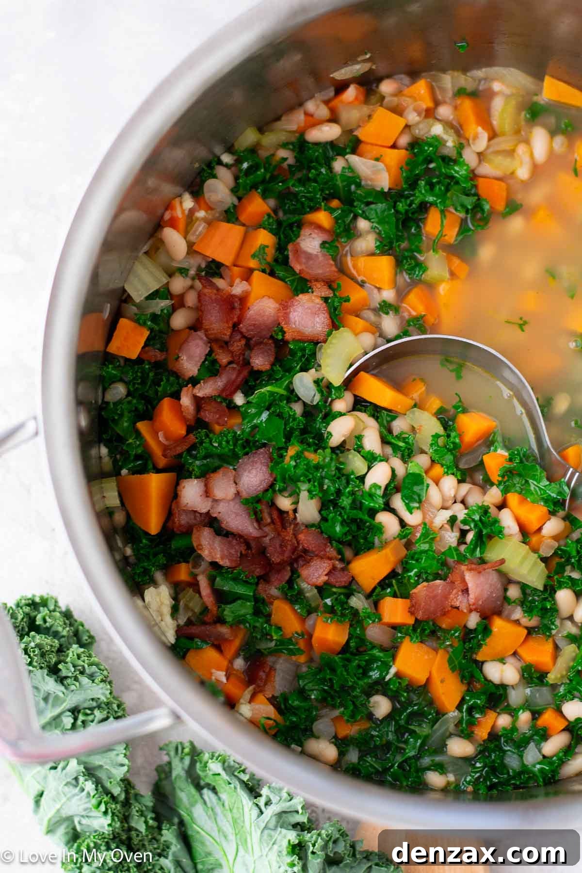 A bowl of Sweet Potato and White Bean Soup with bread