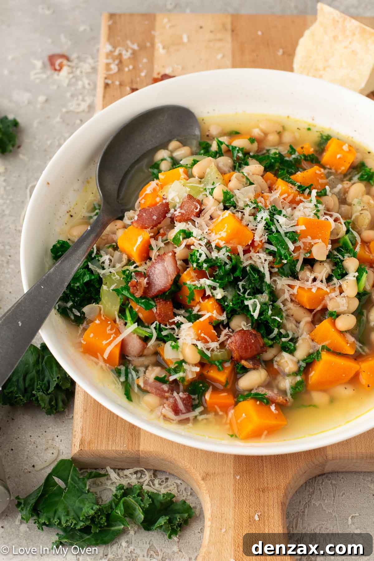 Bowl of Sweet Potato and White Bean Soup garnished with fresh herbs