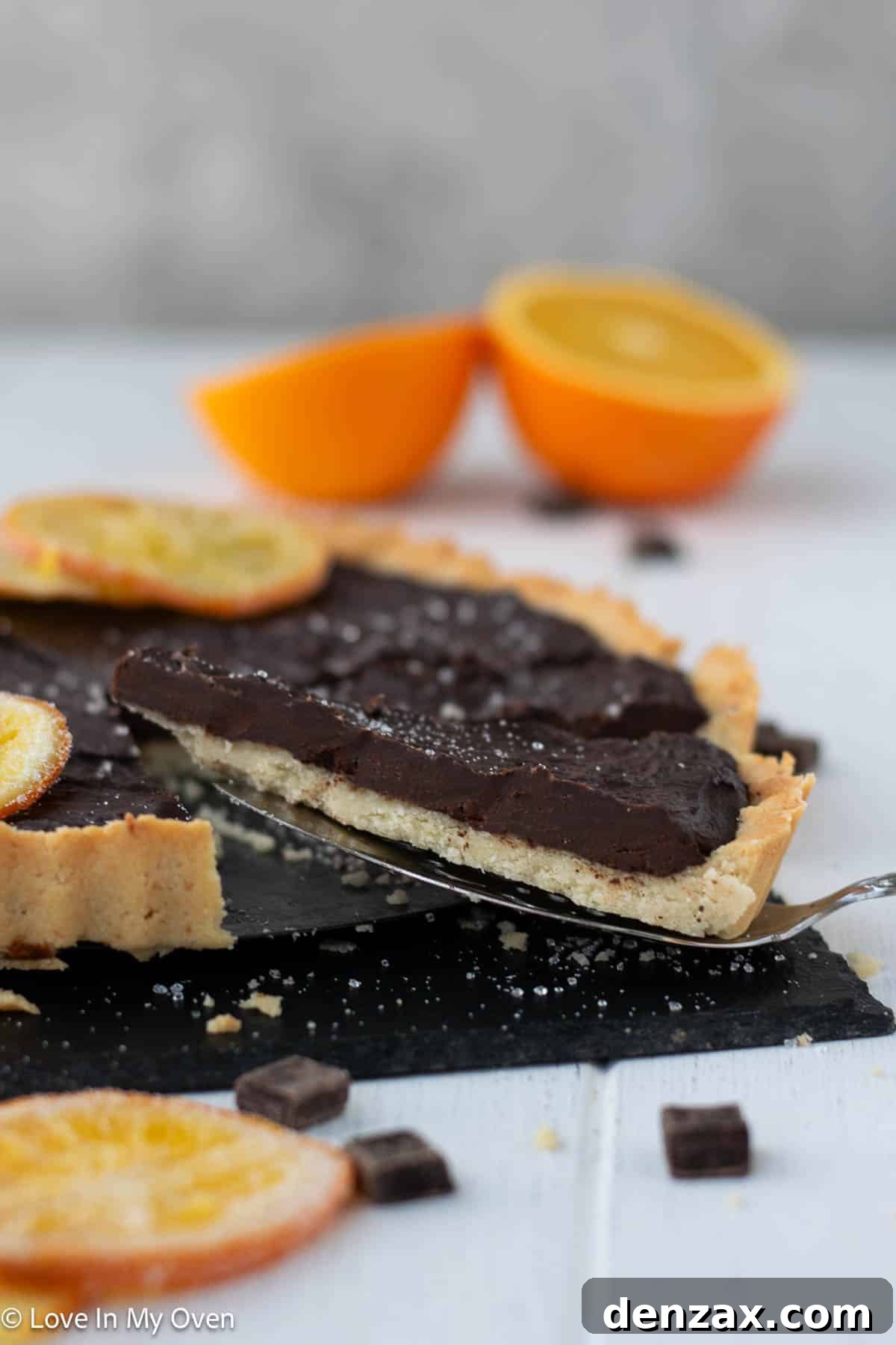 Close-up of chocolate orange tart with fresh orange slices