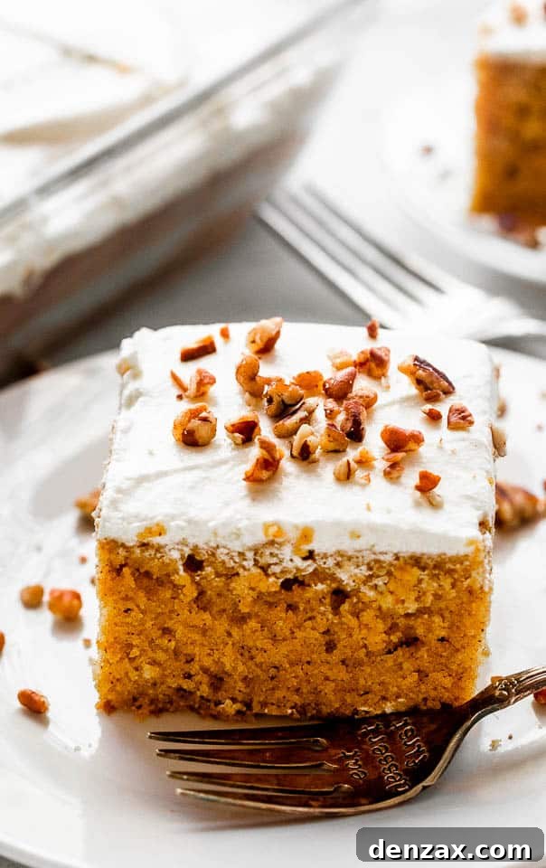 pumpkin bar slice topped with cream cheese frosting a chopped pecans