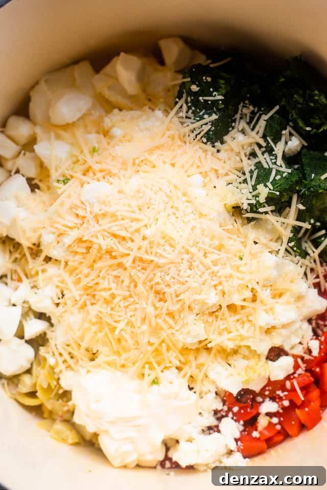 overhead shot of ingredients for spinach artichoke dip in slow cooker