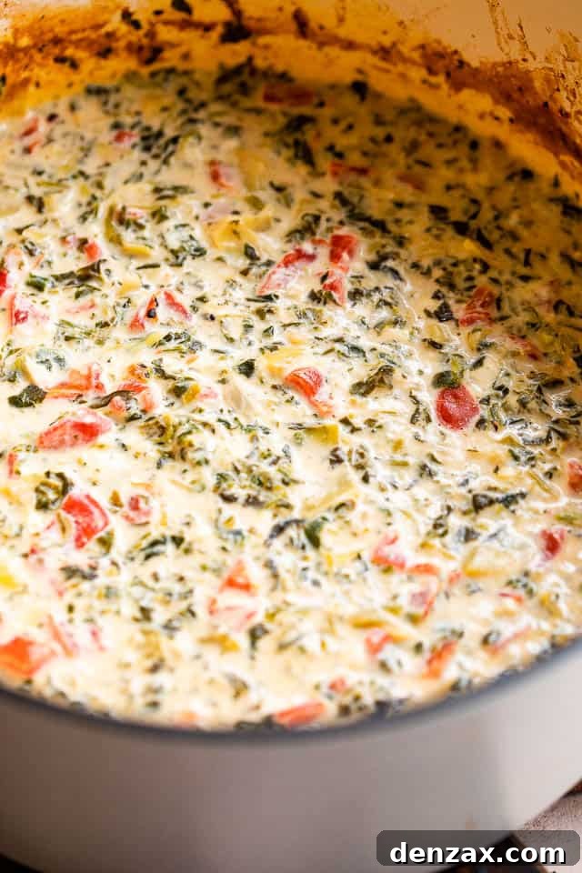 side shot of spinach artichoke dip in slow cooker