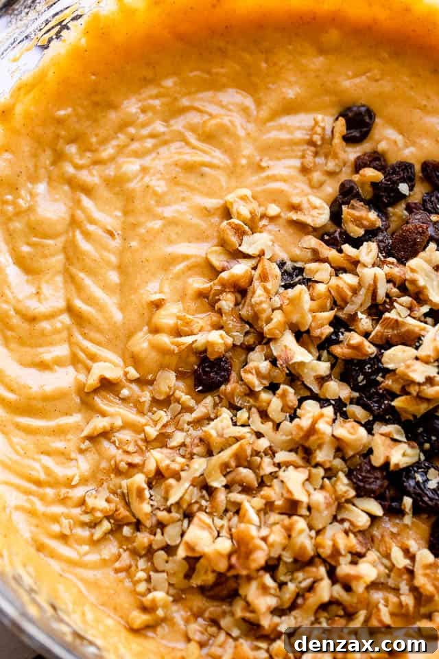 Mixing bowl filled with vibrant orange pumpkin batter, ready for the next steps of creating the ultimate pumpkin swirl bread.