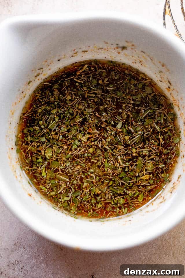 Overhead shot of homemade balsamic vinaigrette in a small white bowl, ready to be drizzled