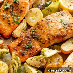 overhead shot of roasted salmon fillets with brussel sprouts and yellow squash