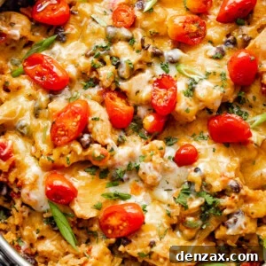 overhead shot of chicken and rice burrito skillet topped with grape tomatoes