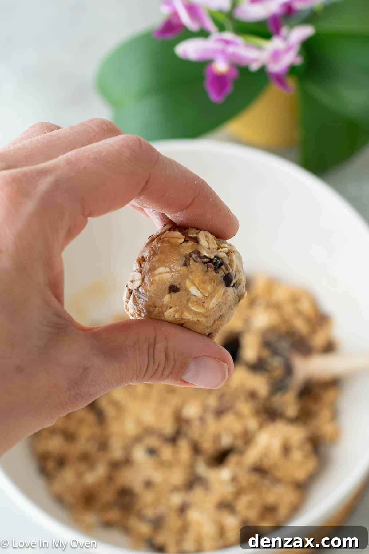 Rolling the peanut butter protein ball mixture into uniform balls by hand.