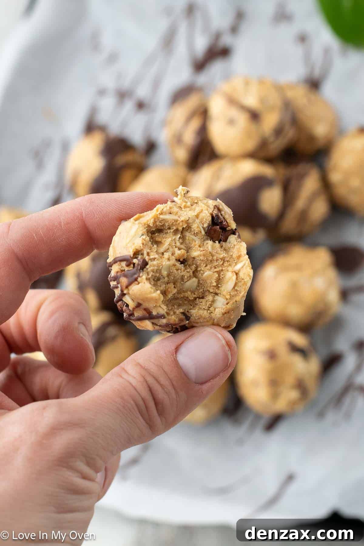 A stack of peanut butter protein balls with chocolate drizzle, showcasing their irresistible texture.