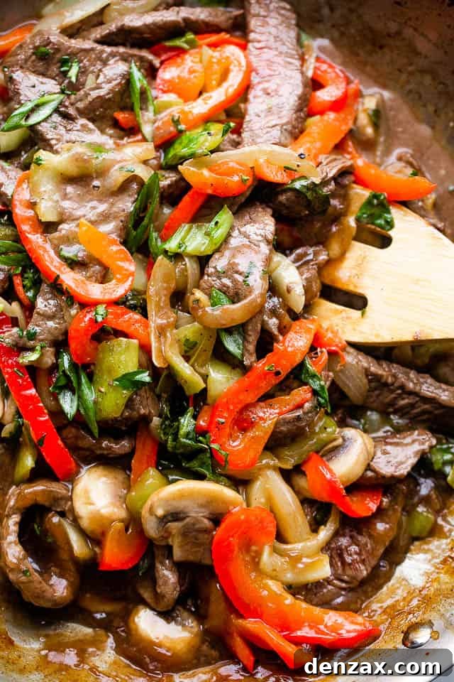 Glazed Honey Balsamic Beef Stir Fry 5 stirring through beef stir fry with vegetables