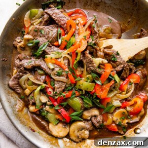 overhead wide shot of a skillet with stir fried beef and vegetables