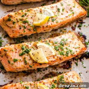 four baked maple mustard salmon fillets on a baking sheet