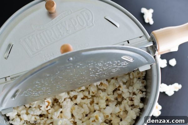 Popcorn kernels being coated with sweet syrup