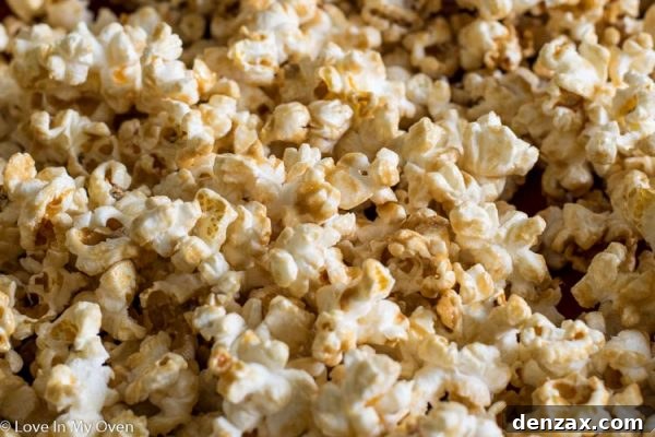 Sweetened popcorn spread on a baking sheet before baking