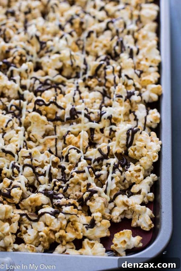 Close-up of white and dark chocolate being drizzled over baked popcorn