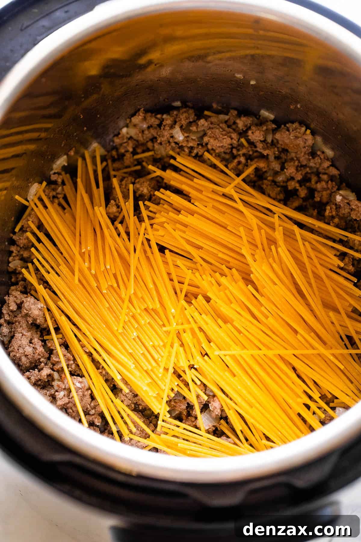 dry spaghetti set over ground beef in the instant pot