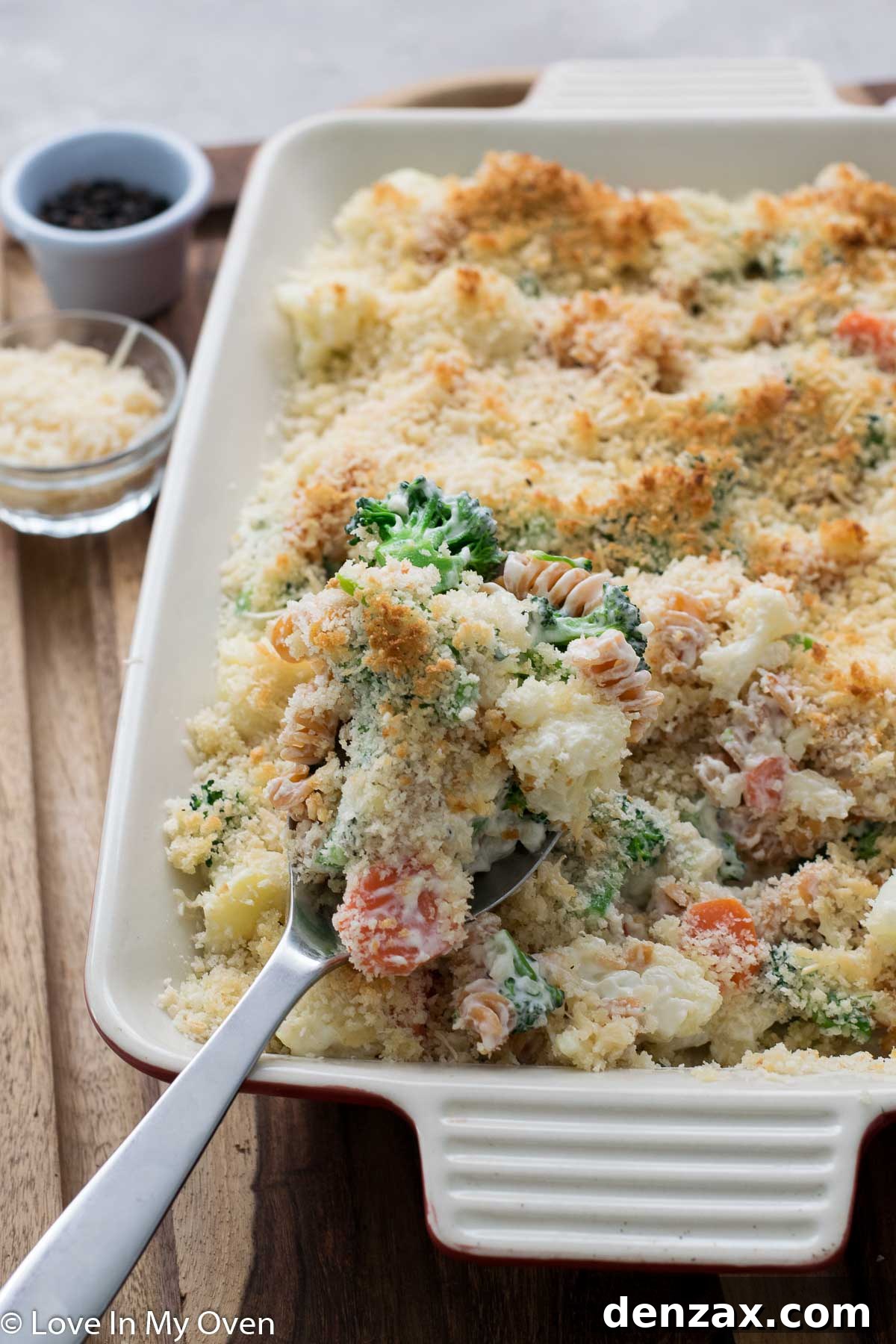 Close-up of a single serving of creamy vegetable casserole on a plate, garnished with fresh parsley.