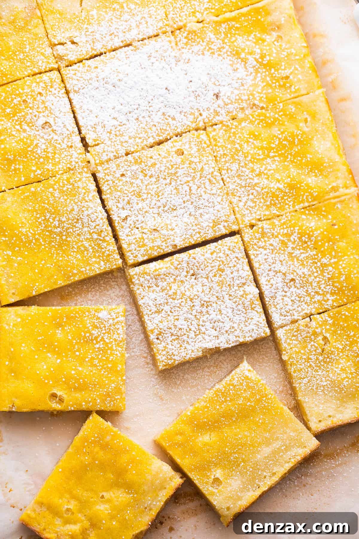 Overhead view of perfectly cut lemon squares dusted with powdered sugar