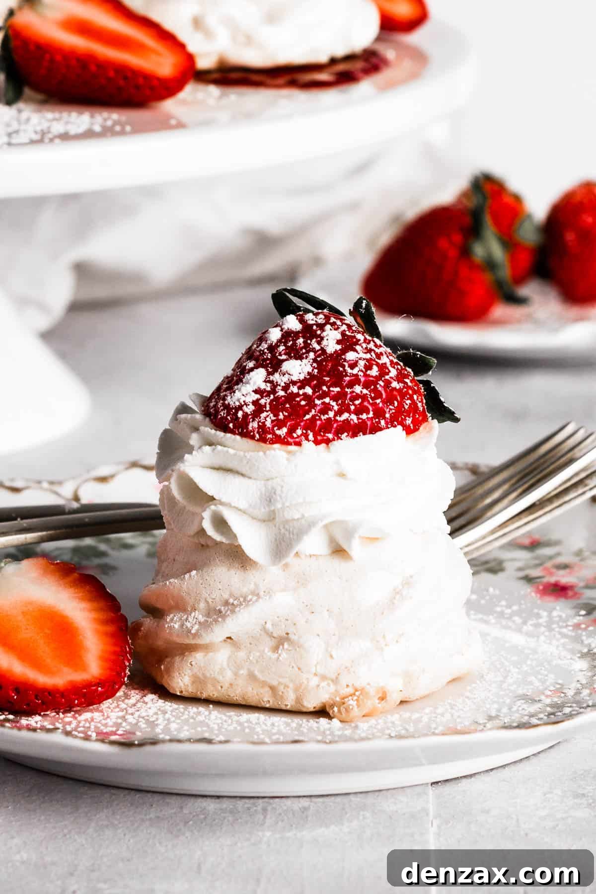 A mini pavlova on a plate with strawberries