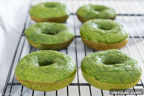 Freshly baked Green Monster Donuts cooling on a wire rack.