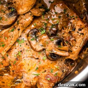 close up shot of pork chops in the instant pot topped with mushroom gravy sauce