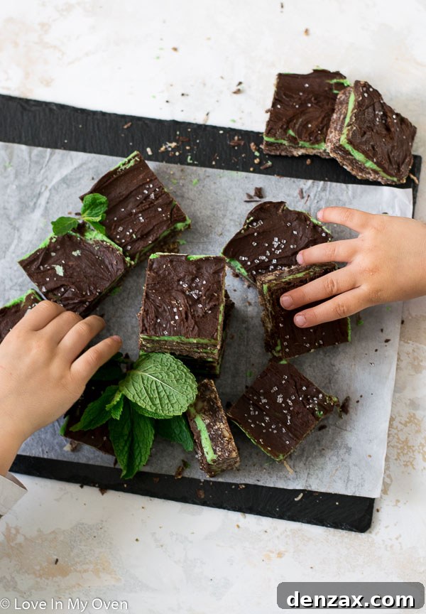 Hand holding a slice of Mint Nanaimo Bar