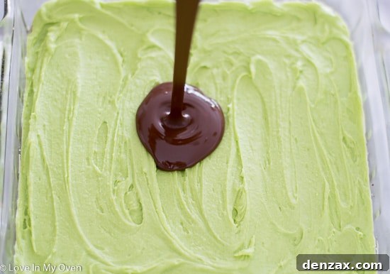 Smooth chocolate topping setting on the Nanaimo bars