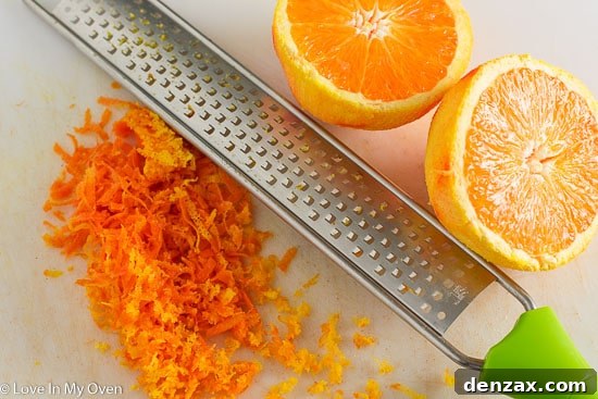 Close-up of orange zest, highlighting the vibrant addition to the cake.