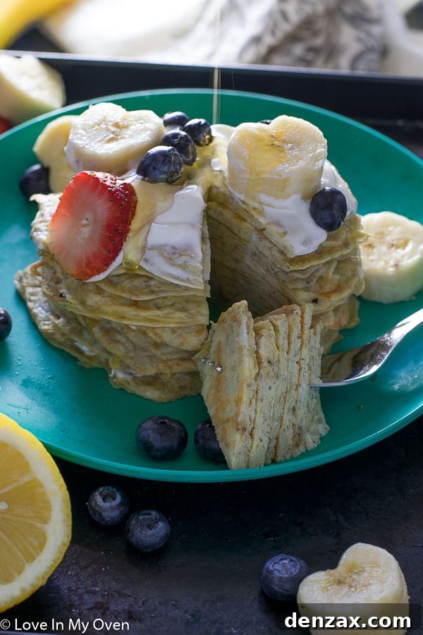 Close-up of fluffy two-ingredient banana egg pancakes stacked on a plate