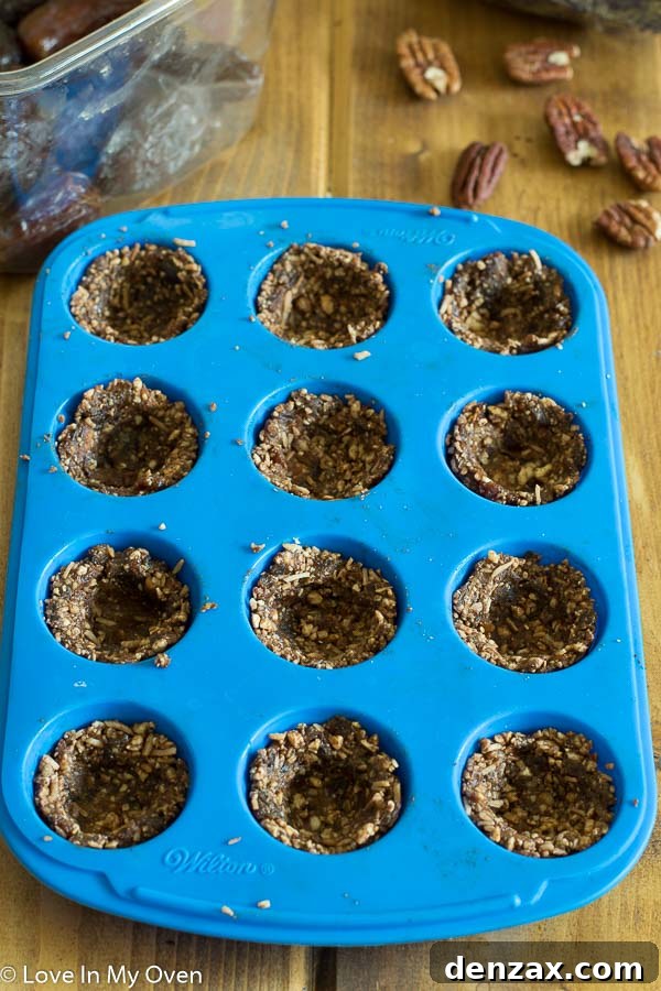 Array of perfectly formed healthy chocolate coconut baskets ready for their ganache filling