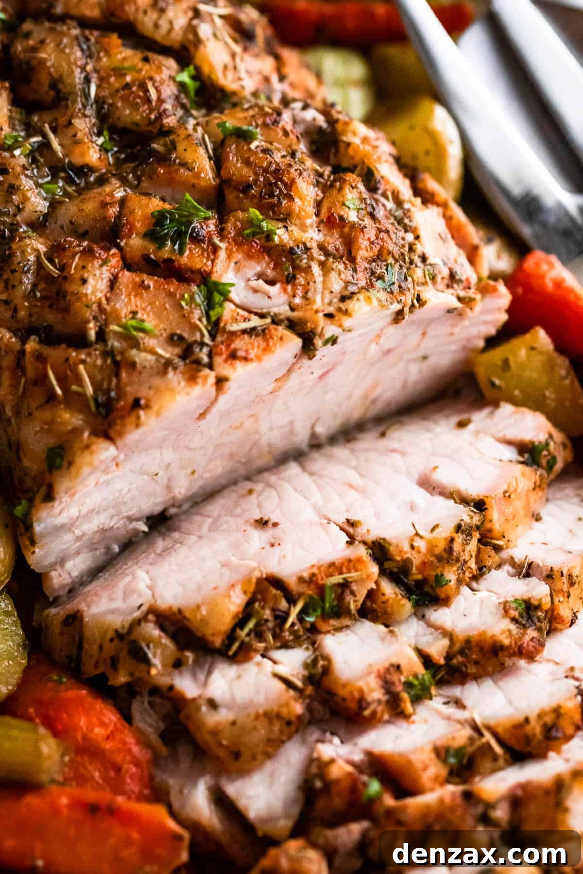 Herb-Crusted Pork Loin and Roasted Root Vegetables 7 up close shot of baked pork loin roast sliced and served with vegetables
