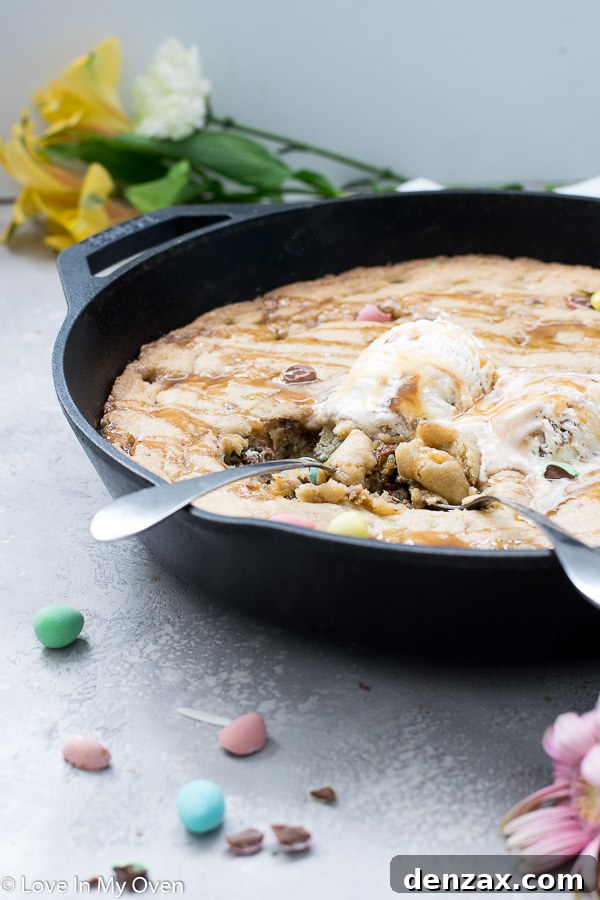 Close-up of a slice of giant mini egg skillet cookie with gooey center