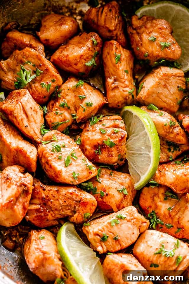 Close-up shot of seasoned taco chicken bites sizzling in a cast-iron skillet.