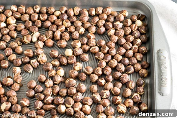 Roasted hazelnuts on a tea towel, ready for skin removal