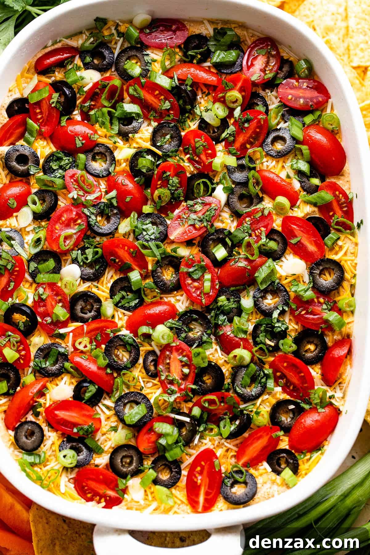 An overhead shot of a delightful seven-layer Mexican dip, showcasing all its colorful layers.