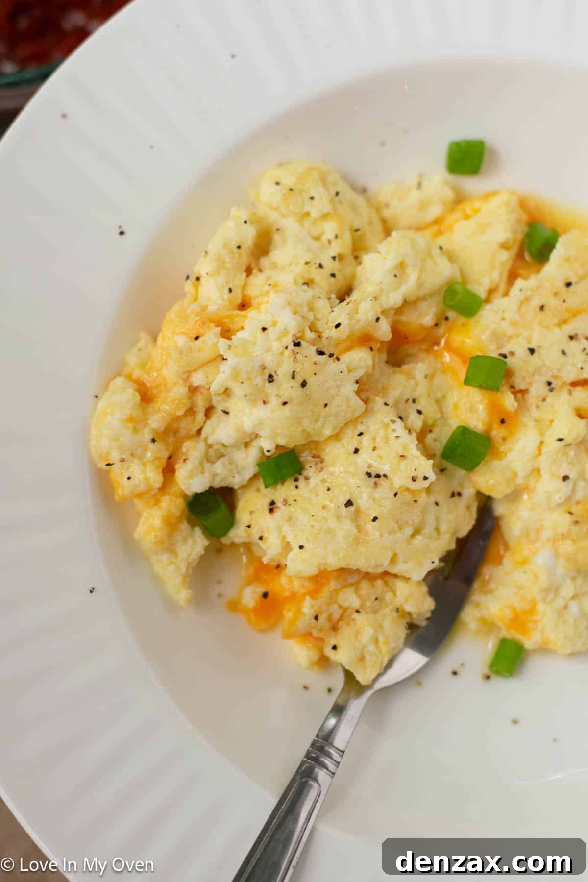 High Protein Scrambled Eggs with cottage cheese and cheddar, served with salsa and green onion