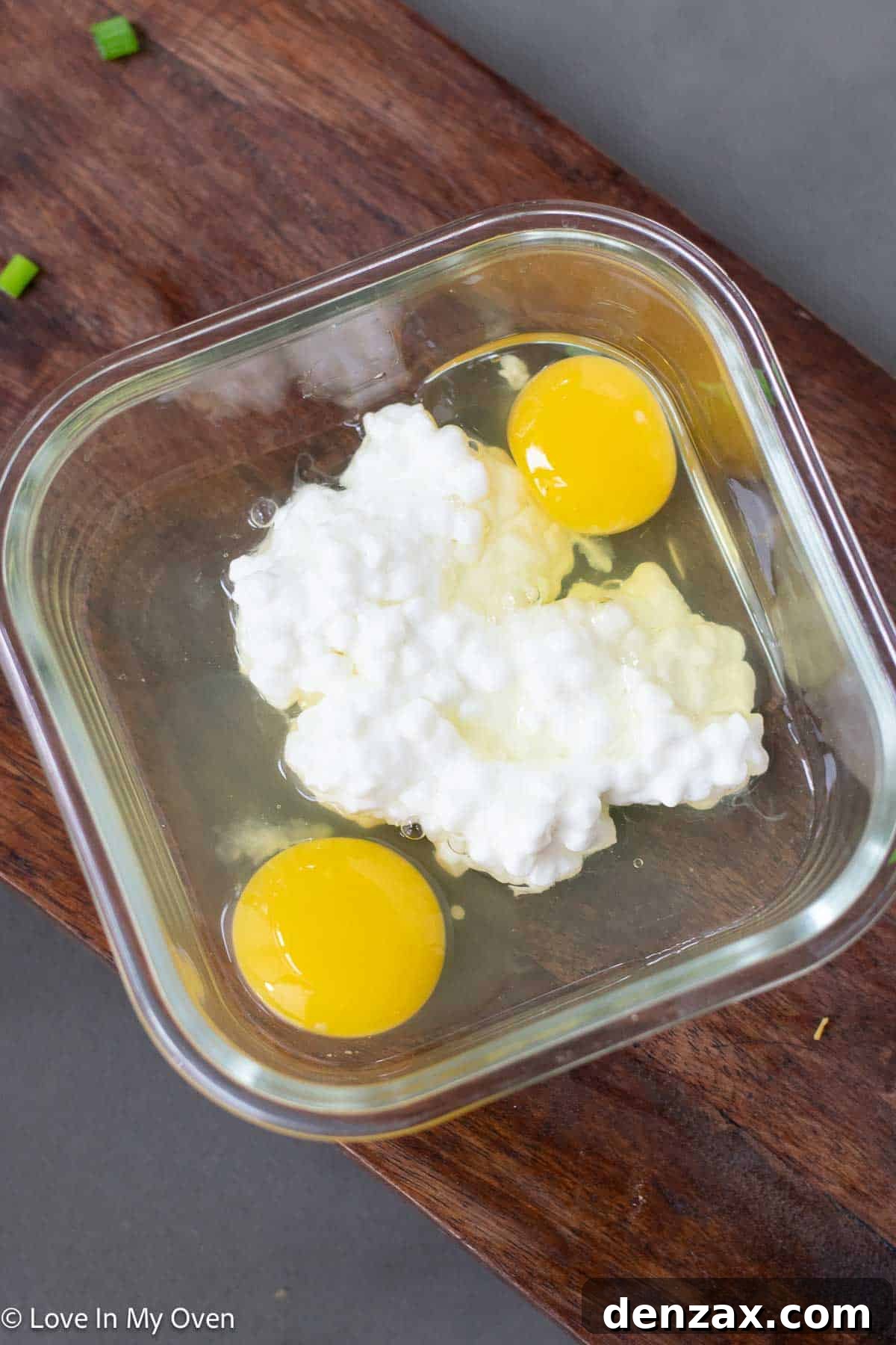 Cracking eggs into a bowl for scrambled eggs