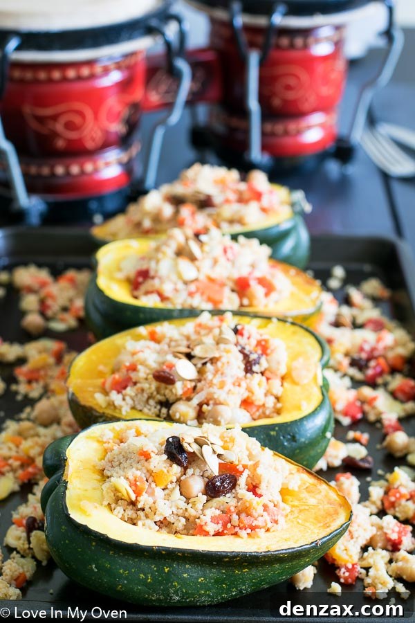 Moroccan couscous stuffed acorn squash on a wooden board