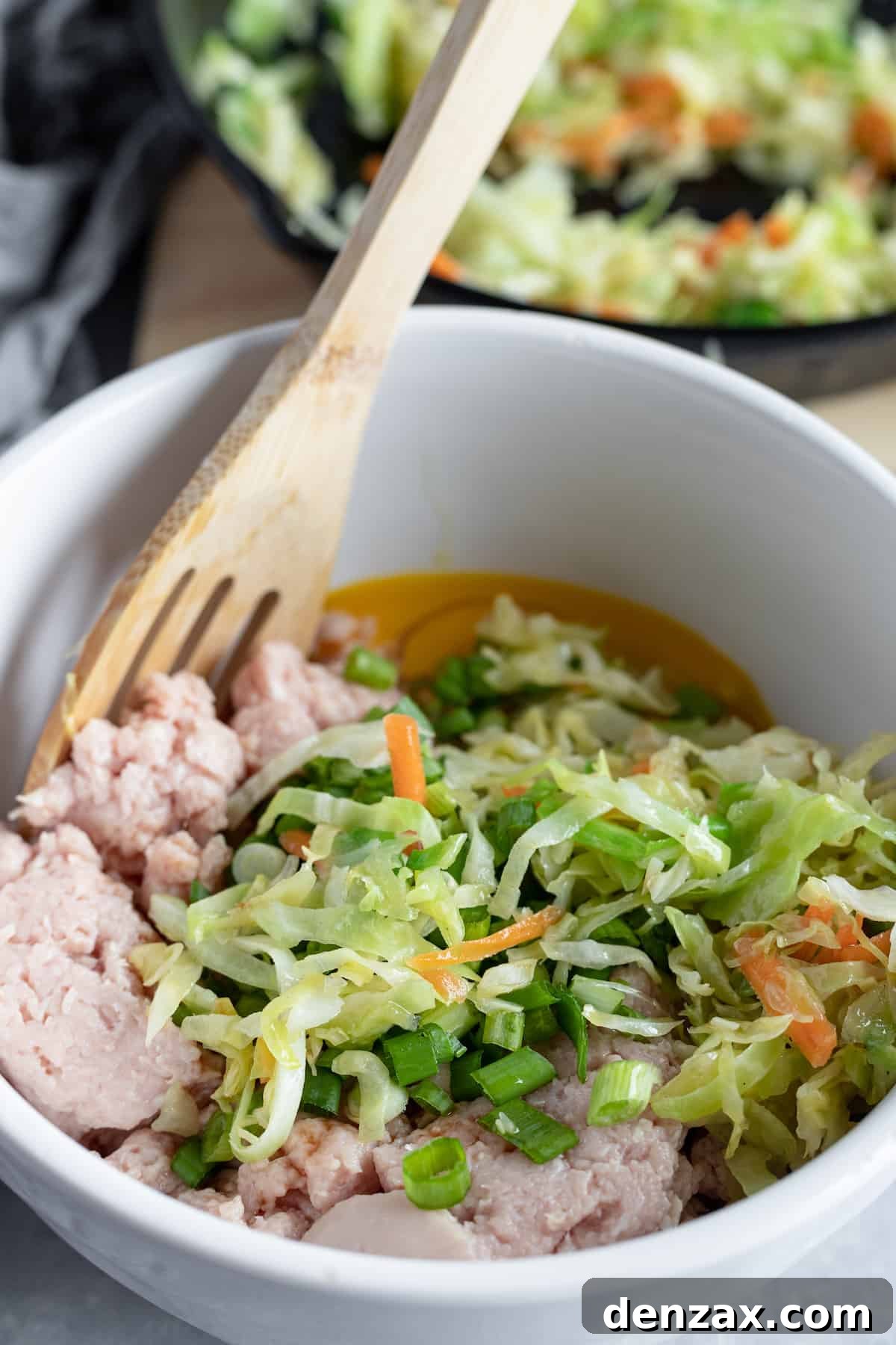 Cooked cabbage coleslaw in a bowl with the other filling ingredients