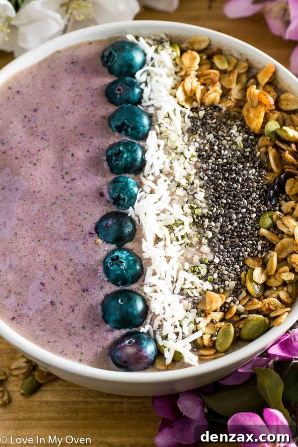 Final shot of cherry coconut smoothie bowl with spoon and fresh cherries